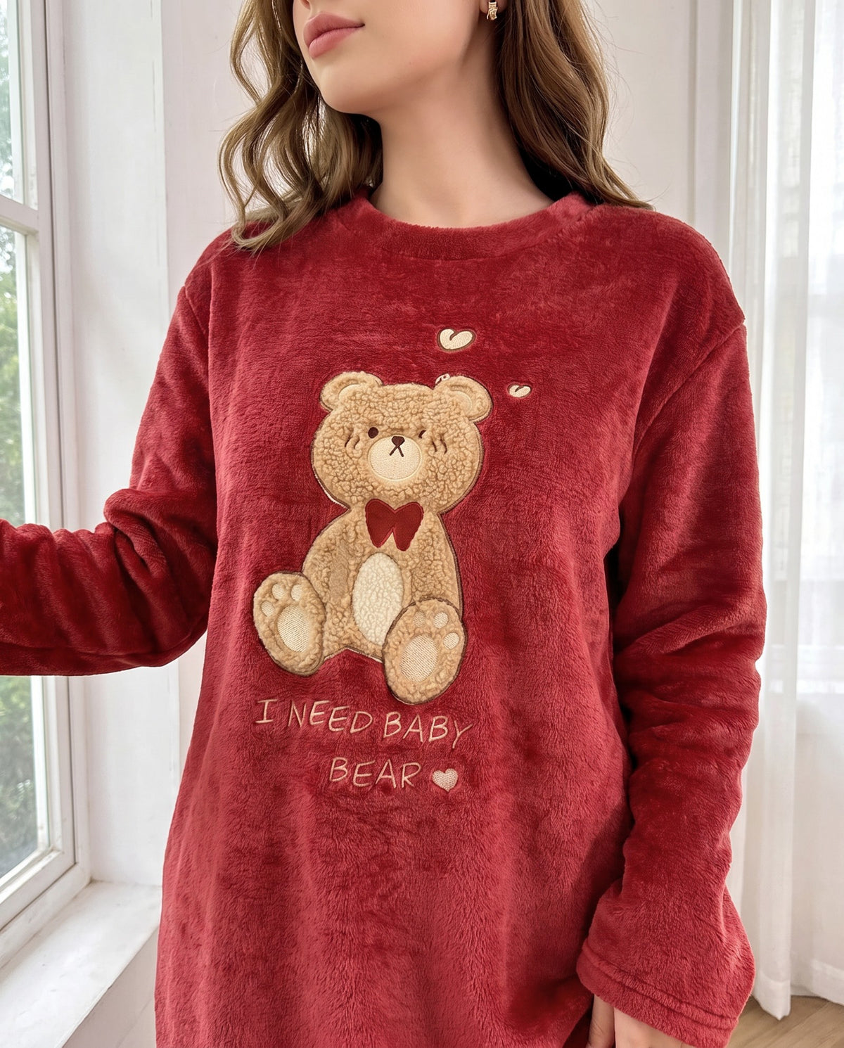 Close-up of the sherpa teddy bear appliqué, red bow tie and I NEED BABY BEAR stitching