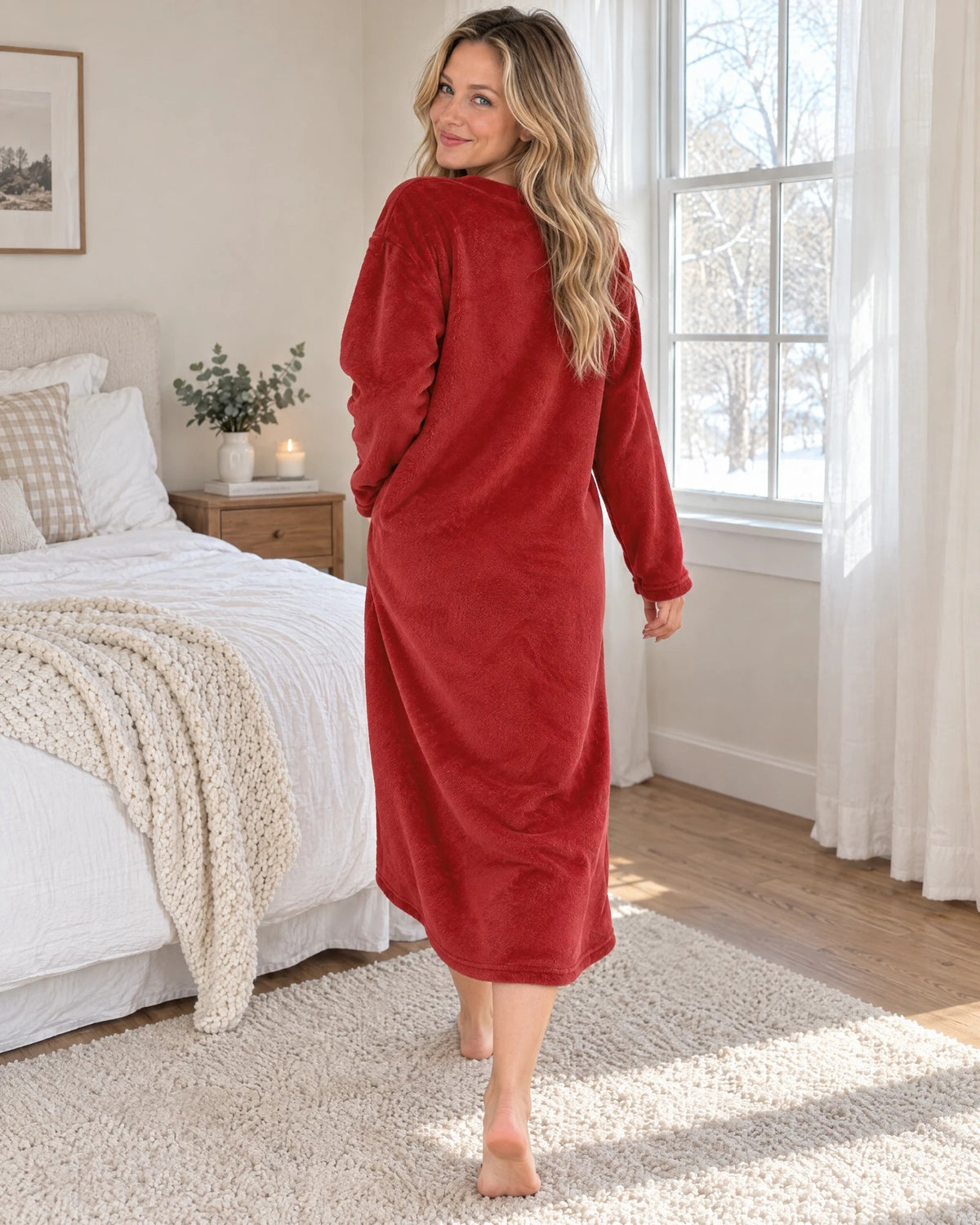 Back view of the Bear Hug Fleece Nightgown by a snowy window, plain back and mid-calf length