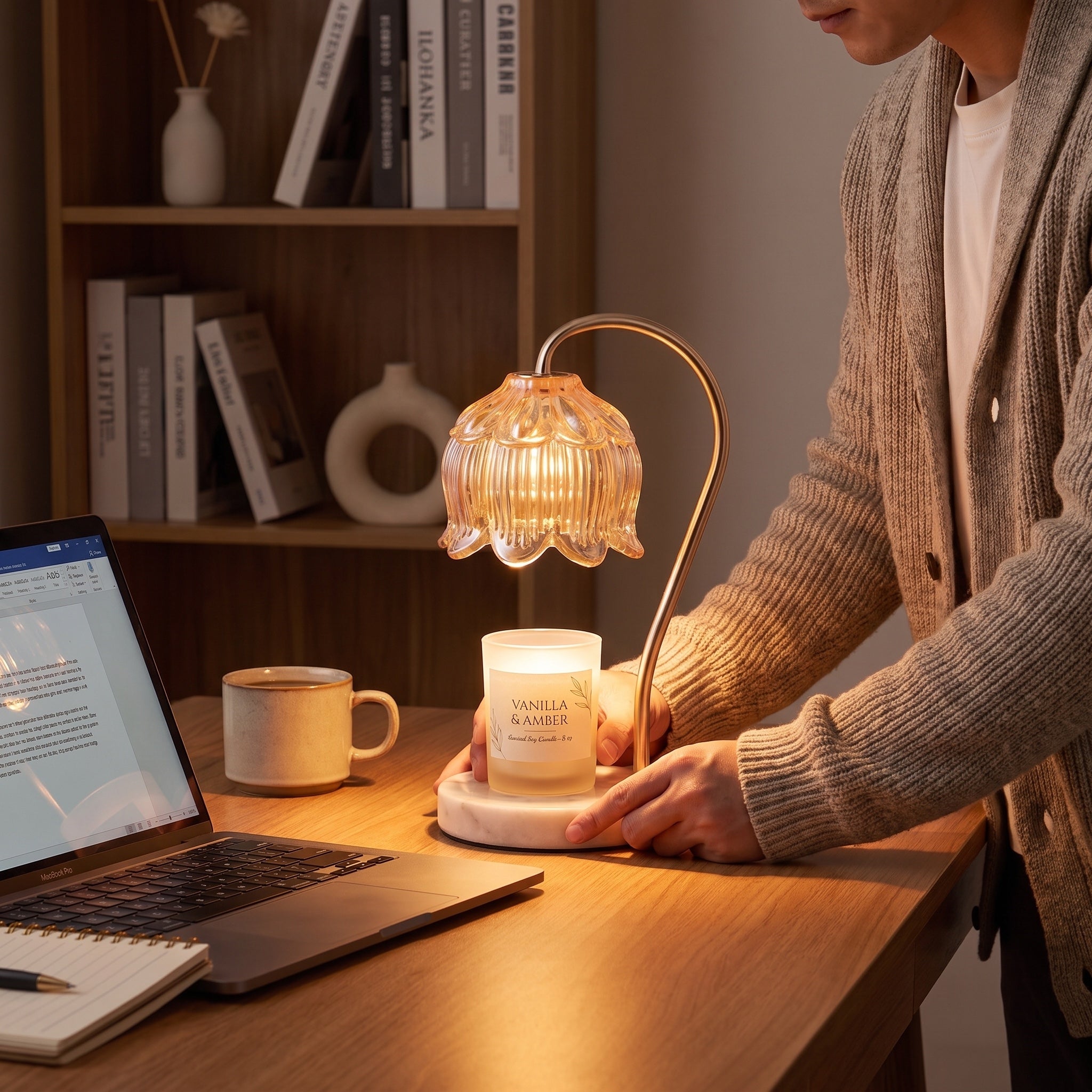 Man placing the Marble Bloom candle warmer on a home office desk
