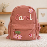 Dusty rose corduroy backpack with hand knitted name Carol