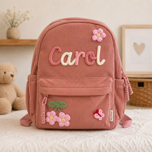 Dusty rose corduroy backpack with hand knitted name Carol