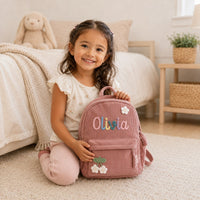 Toddler with small personalized knitted name backpack
