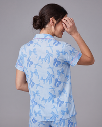 Blue button-up pajama shirt with notched lapel — soft stretch sleep top with bow print