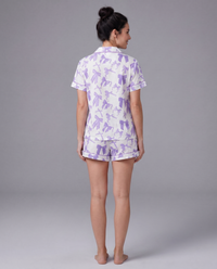 Purple bow-print pajama shirt detail — dreamy lavender stretch fabric with matching piping