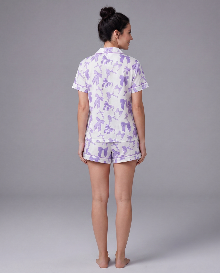Purple bow-print pajama shirt detail — dreamy lavender stretch fabric with matching piping