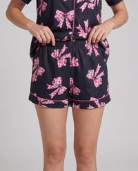 Black Ribbon Dreams pajama set styled together — coquette-coded bow-print loungewear