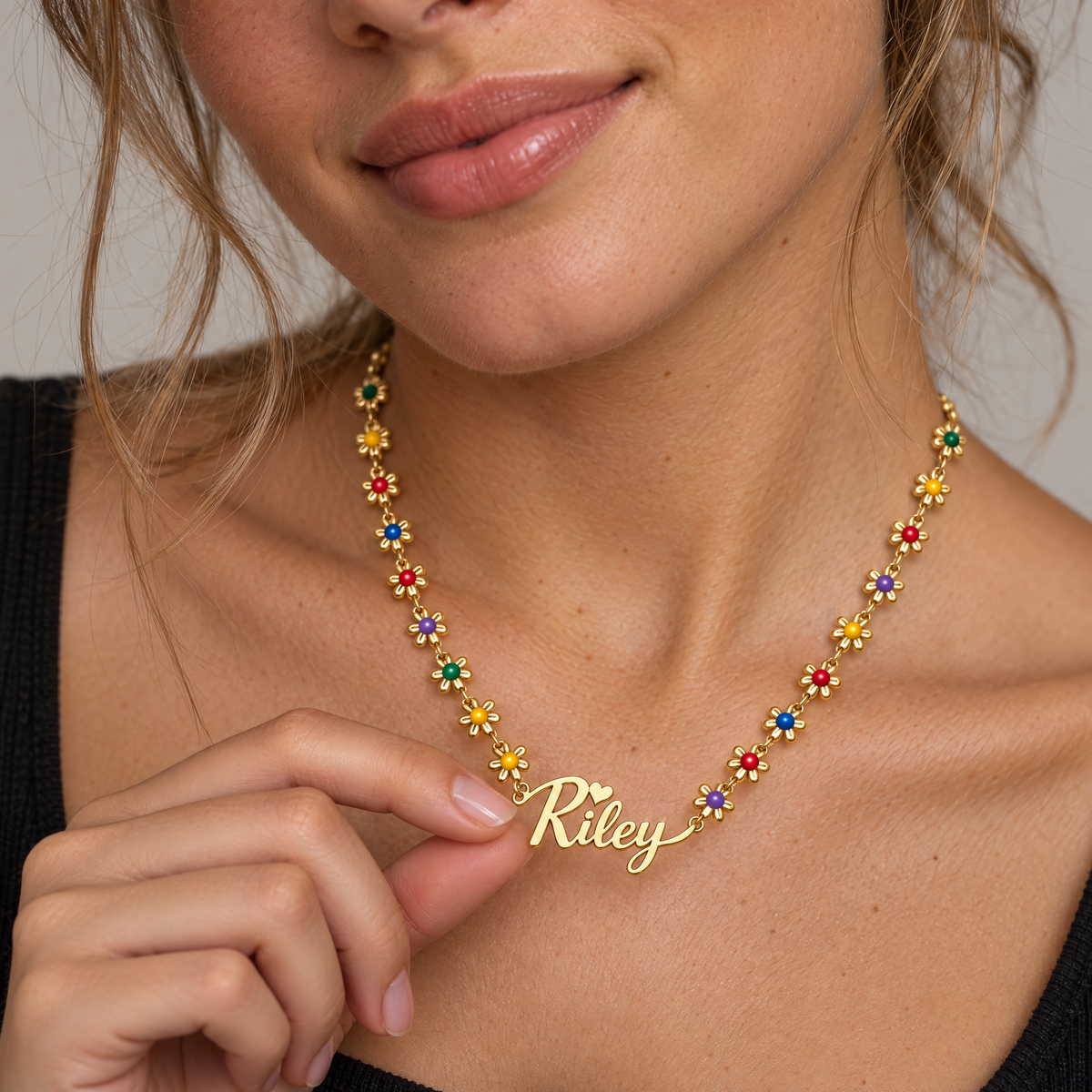 Gold | Riley flower name necklace worn by a woman in her 20s
