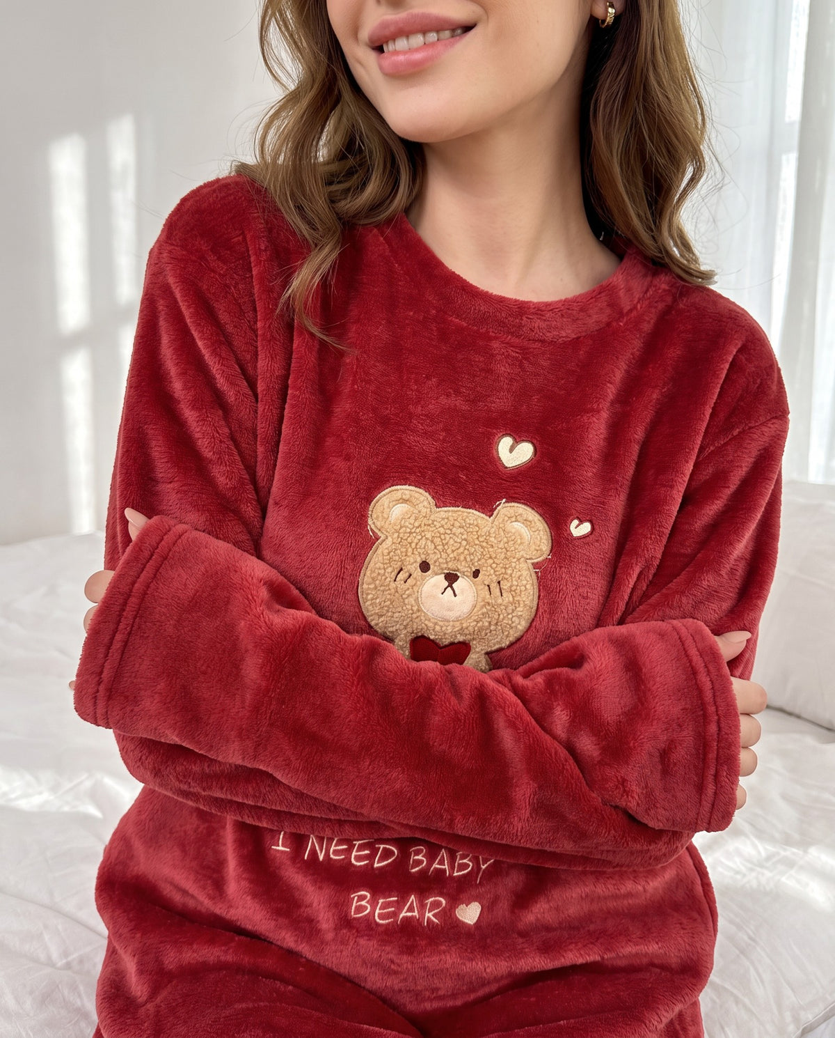 Woman hugging herself in the Bear Hug Fleece Nightgown, long sleeves and soft cuffs