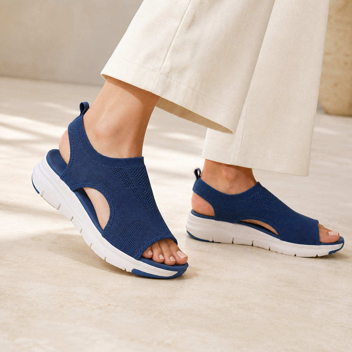 Cloudstep Comfort Sandal navy worn mid-step with white cropped pants