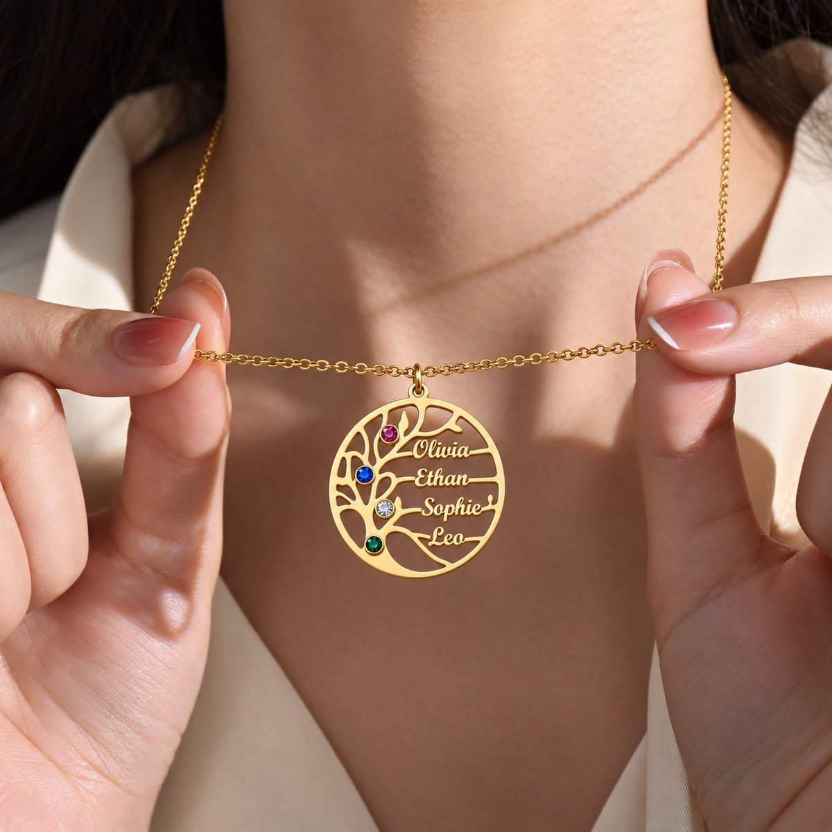 Gold | model holding family tree pendant close-up