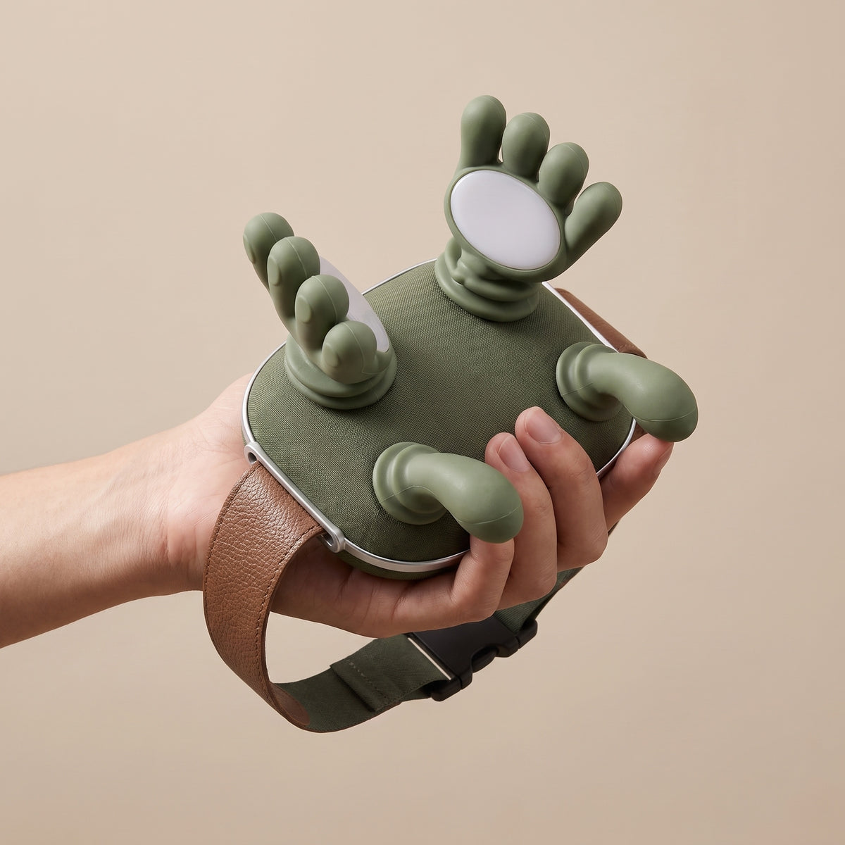 KneadFlow massager held in one hand showing compact lightweight size