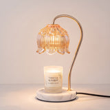 Marble Bloom Candle Warmer melting a scented soy candle with warm light — no flame