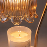 Close-up of the ribbed glass bloom shade glowing over an evenly melted candle