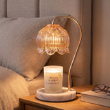 Marble Bloom Candle Warmer glowing on a bedroom nightstand at evening