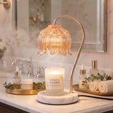 Marble Bloom lamp on a marble bathroom vanity with rolled towels and eucalyptus