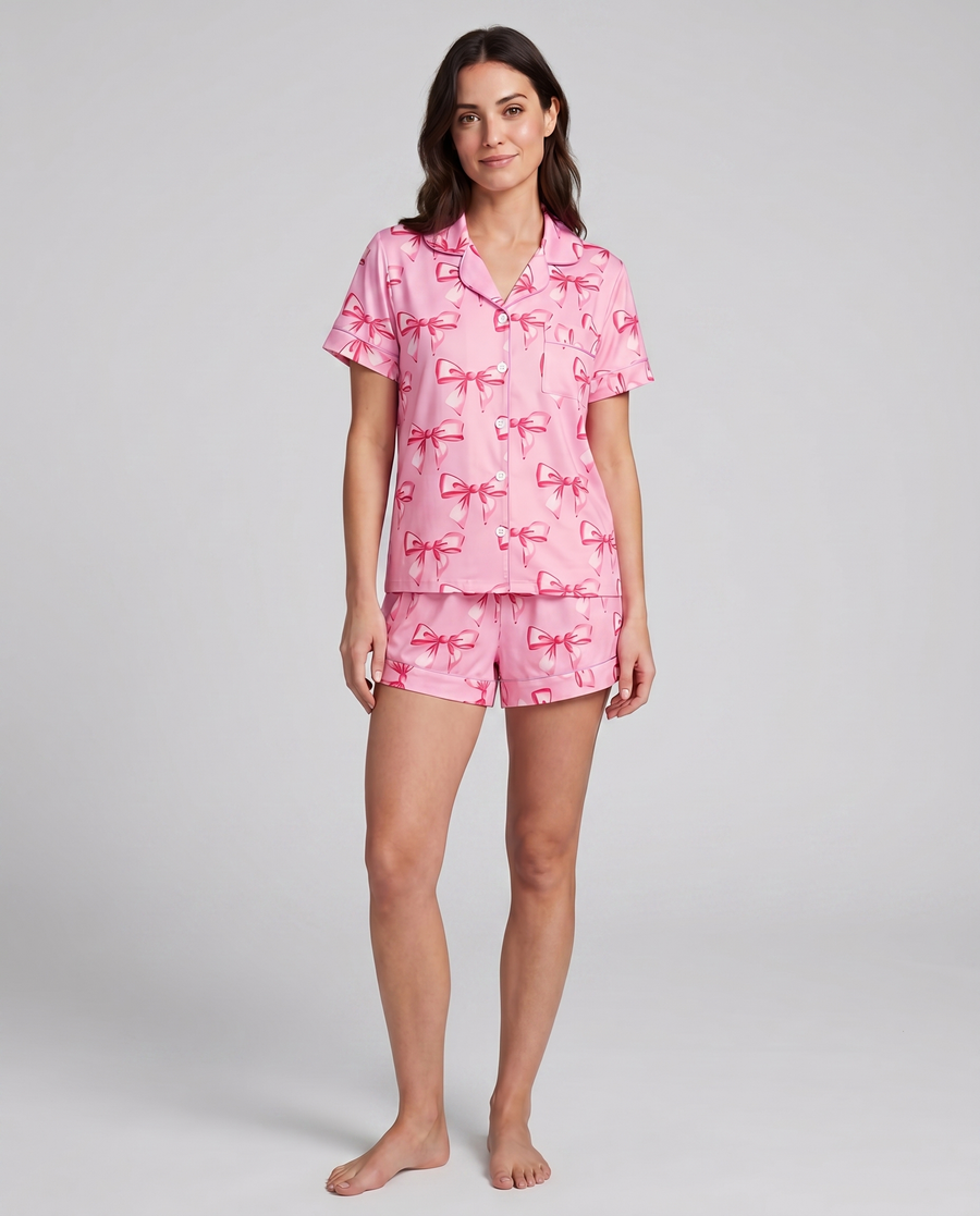 Pink coquette ribbon-bow pajama set on model — front lifestyle view of stretch loungewear