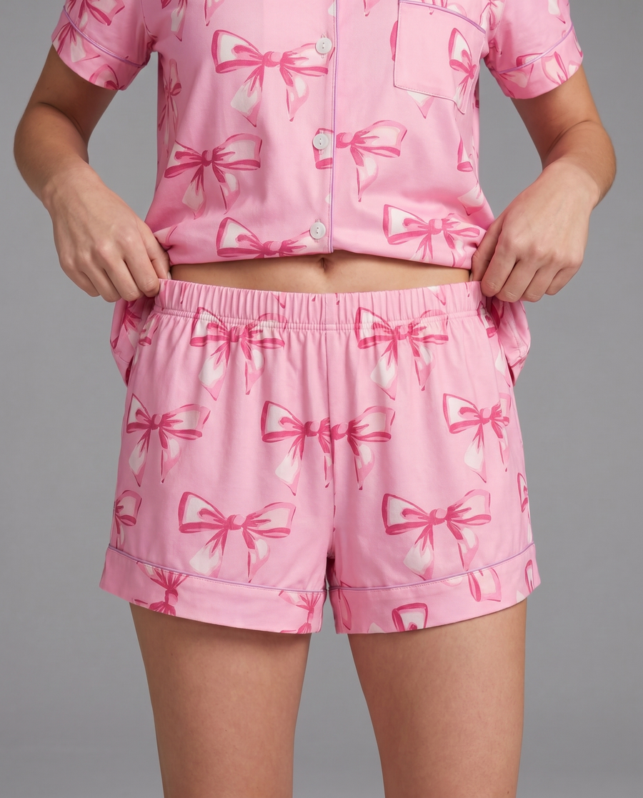 Pink button-up pajama shirt with darker bows — feminine stretch sleep top