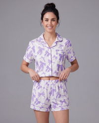 Purple lavender ribbon pajama set on model — soft cream and lilac stretch loungewear