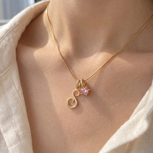 Gold | A young woman wearing the gold initial S necklace, close-up on the collarbone