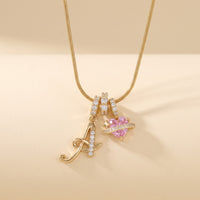 Gold script initial A necklace with pink heart charm