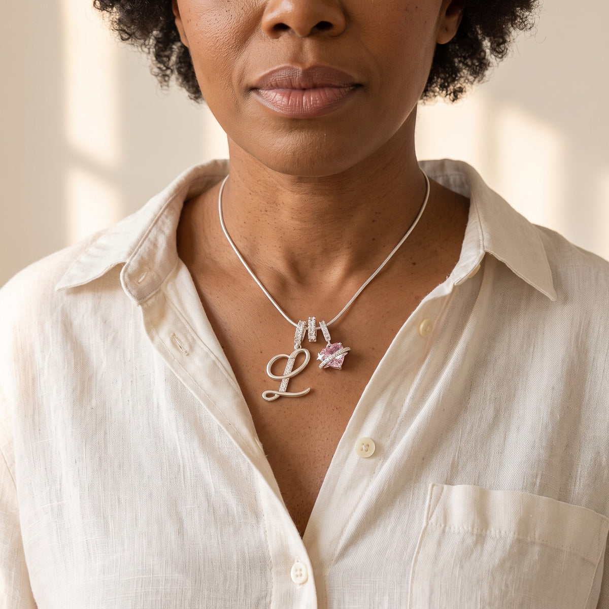 A woman in her 50s wearing the silver initial L necklace