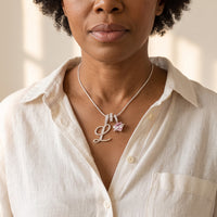A woman in her 50s wearing the silver initial L necklace