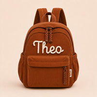 Brown corduroy backpack with Theo knitted in cream wool