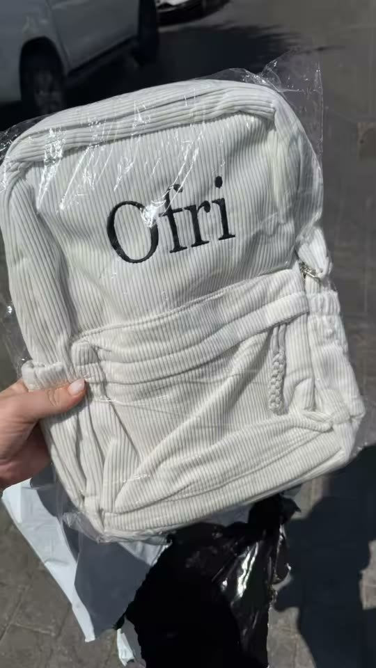 Off white backpack with Ofri in black lettering, just unwrapped