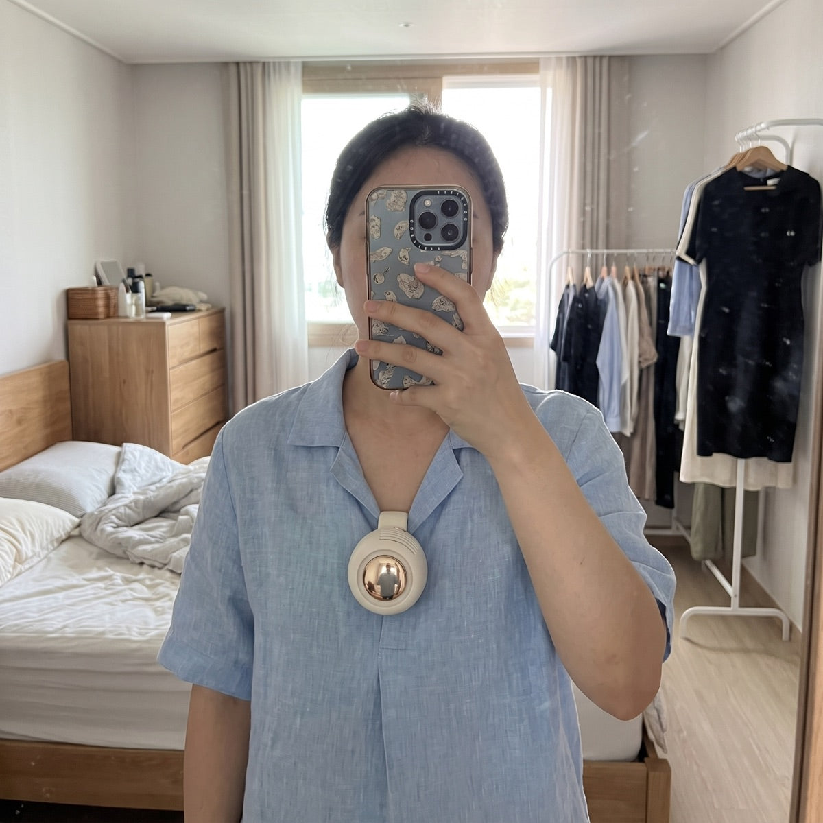 Customer photo — Cream White ChillClip clipped to a blouse collar
