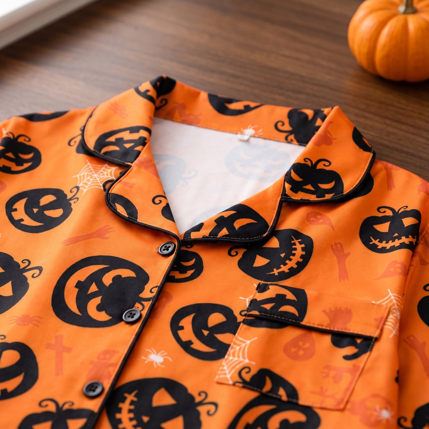 Close-up of the Pumpkin Dreams pajama set collar, black piping and chest pocket