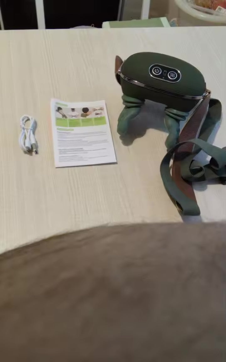 KneadFlow unboxed on a table with strap, manual and charging cable