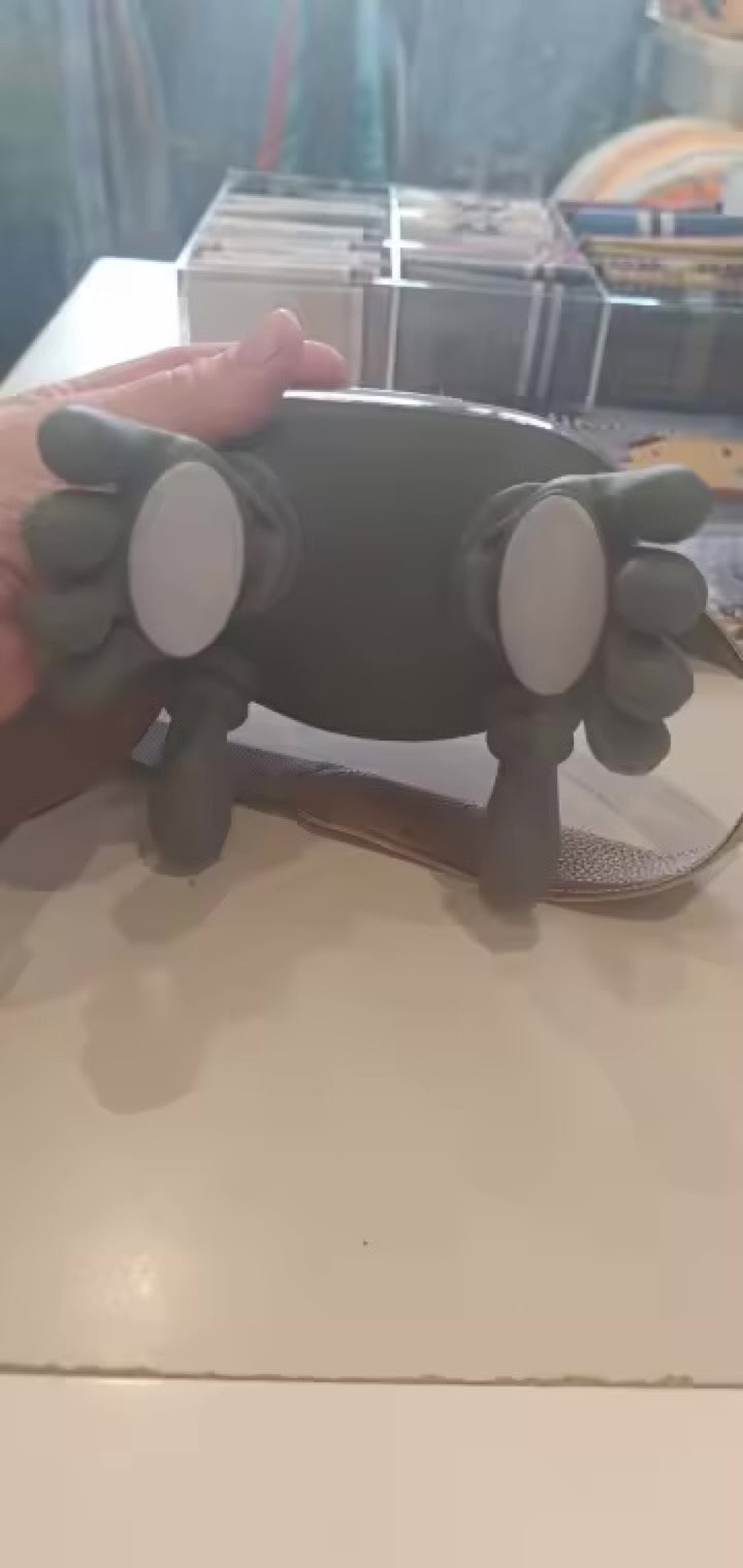 Hand holding the KneadFlow showing the two massage palms