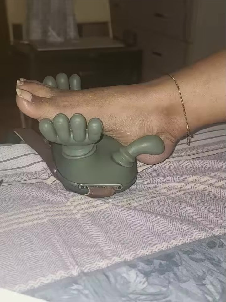 KneadFlow being used to massage a foot on the bed