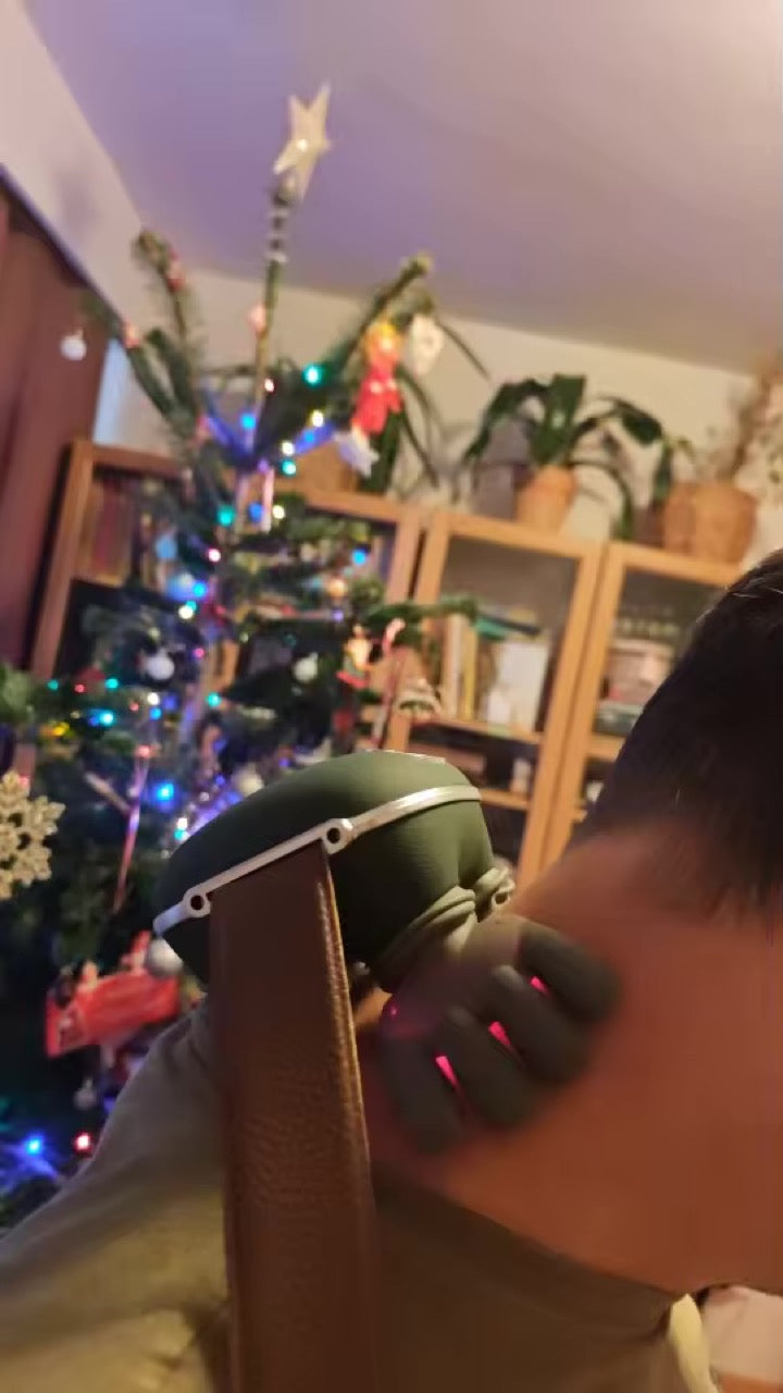 Customer using KneadFlow on his shoulder by the Christmas tree