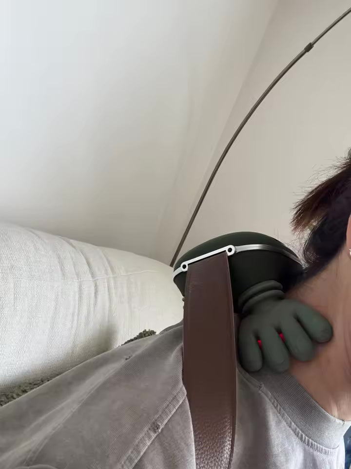 Customer relaxing on the couch with KneadFlow on her neck