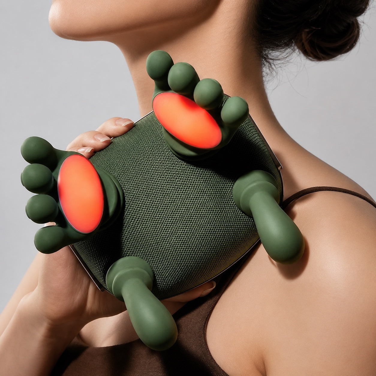 KneadFlow twin silicone hands with glowing warm red palms held against the neck